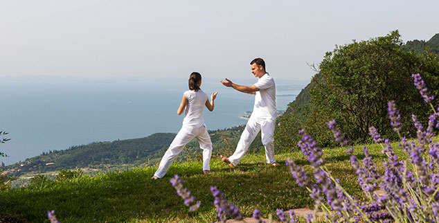 Practice Tai Chi as a healthy active couple on holiday at Lefay
