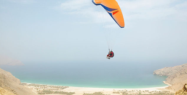 Go Paragliding at the luxury Six Senses Zighy Bay in Oman