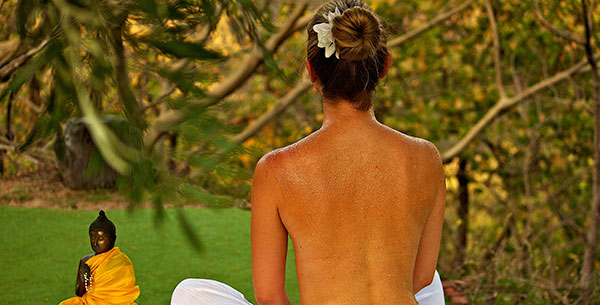 Woman practicing yoga out doors at Ananda in the Himalayas