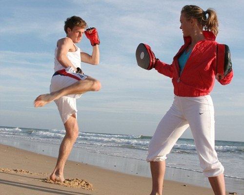 One-on-one kickboxing session on the beach