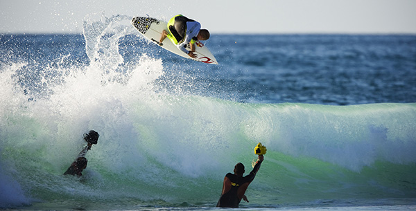 Three people surfing in the waves at Paradis Plage