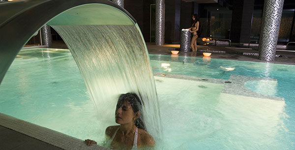 woman in an indoor pool at a resort