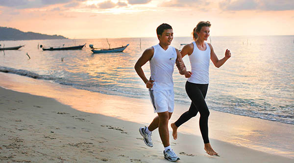 Personal trainer beach jogging at Samahita