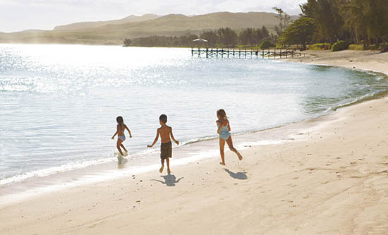 three kids running on the Beach at Shanti Maurice
