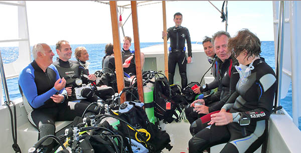 Group of people in diving gear on a boat