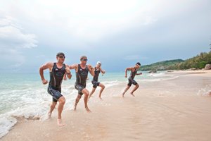 Group of people emerging from the sea whilst on a Triathlon training retreat at Thanyapura Health and Sports Resort in Phuket