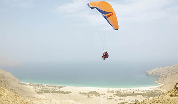 Paragliding at Zighy Bay over the mountains whilst on a wellness retreat