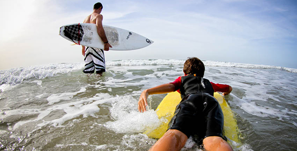 Learn to surf the waves at Paradis Plage