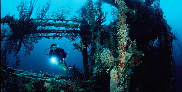 Person diving with torch on