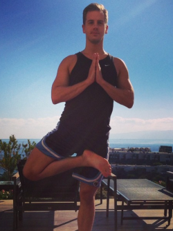 Paul holding the Vrksasana or 'Tree Pose' practicing yoga