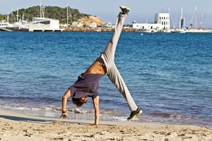 Beach cartwheel staying active