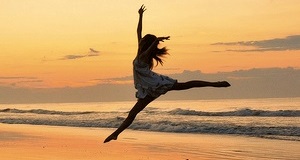 Girl jumping on the beach