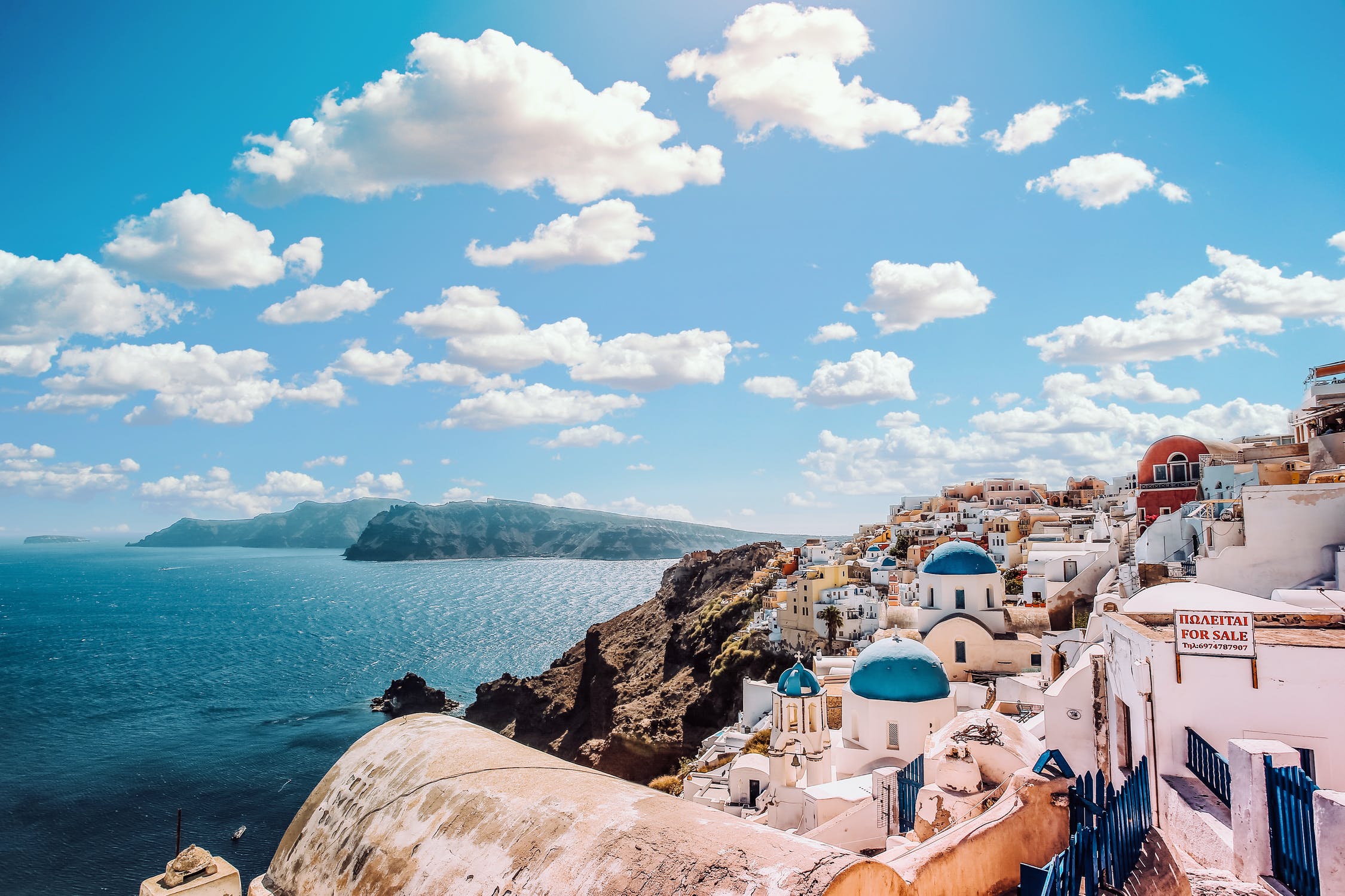 Image of Santorini featuring the iconic blue and white buildings looking out over the sea