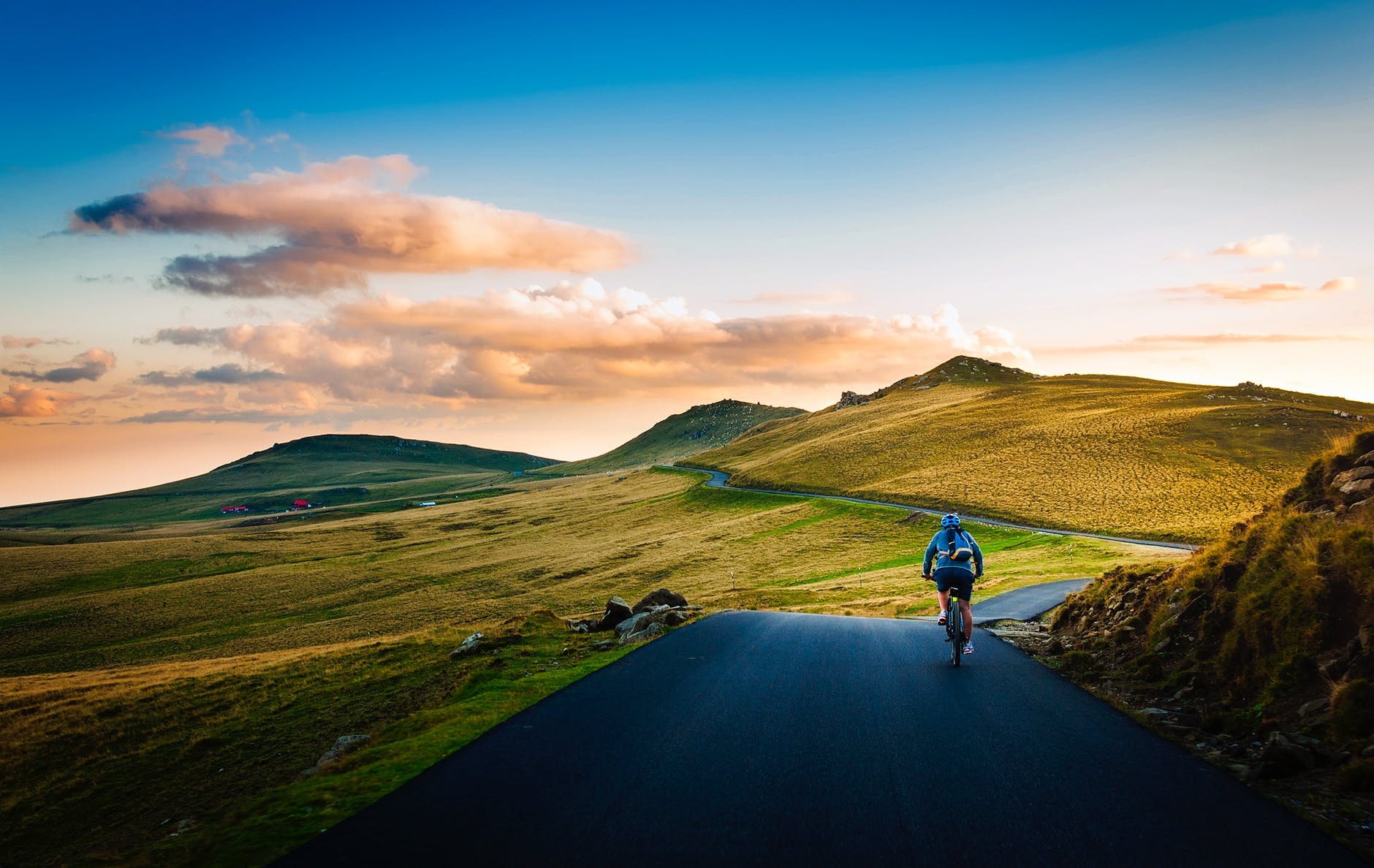 Man cycling through open countryside