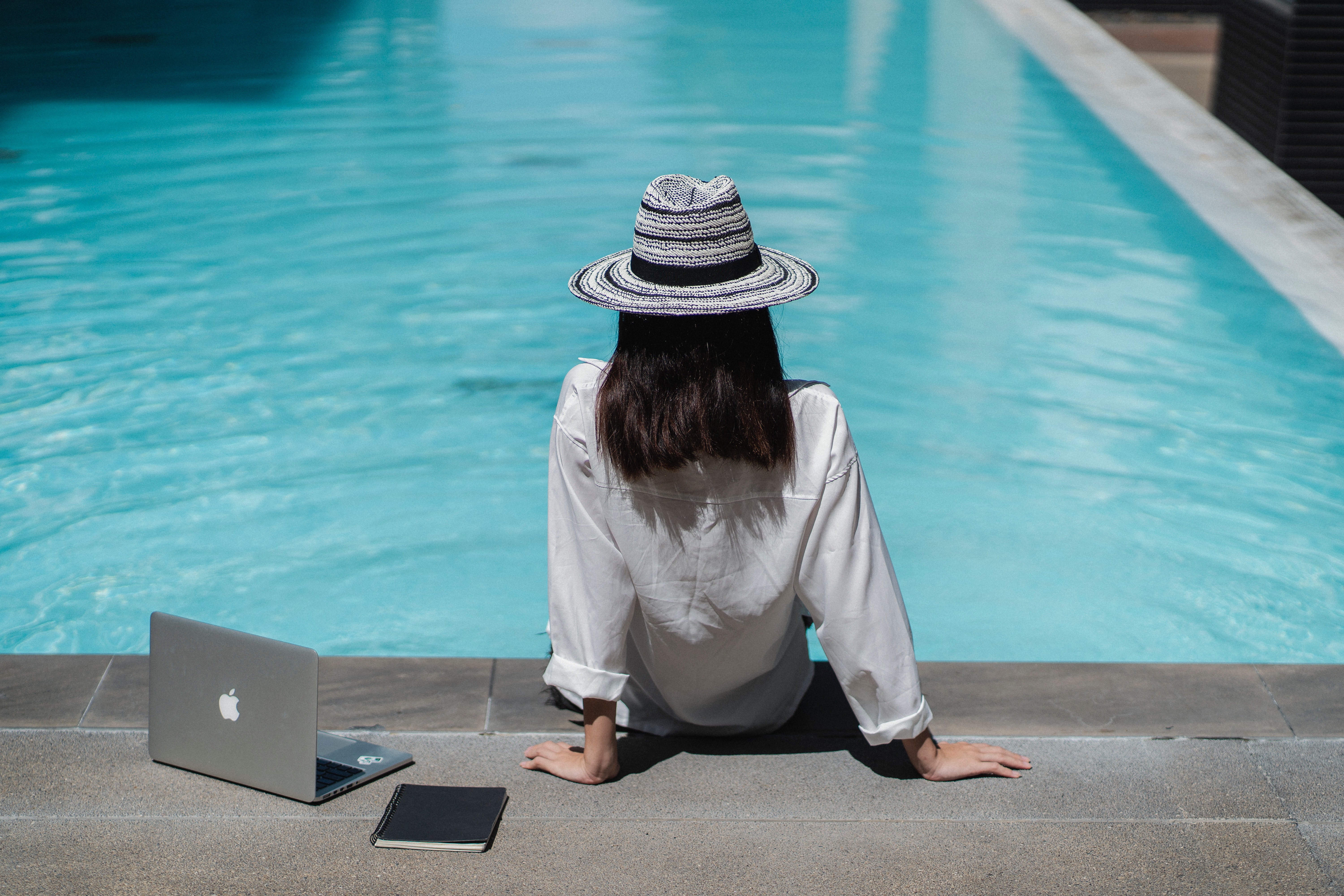 woman working online by the pool