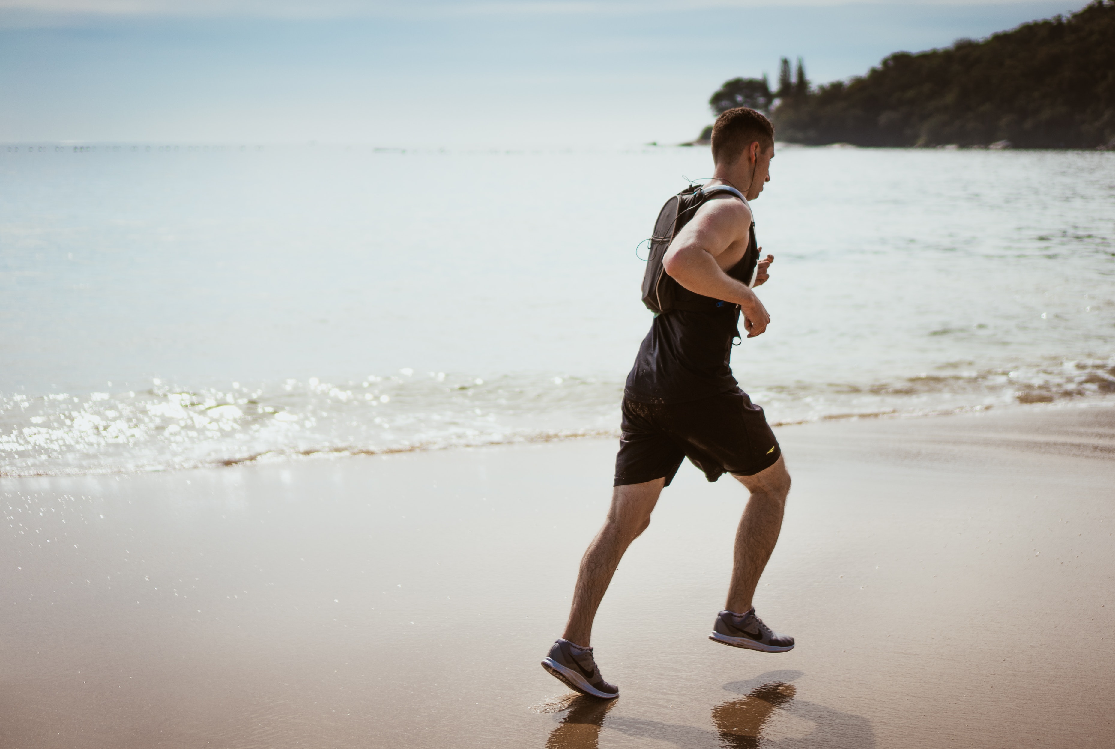 Man running along the beach