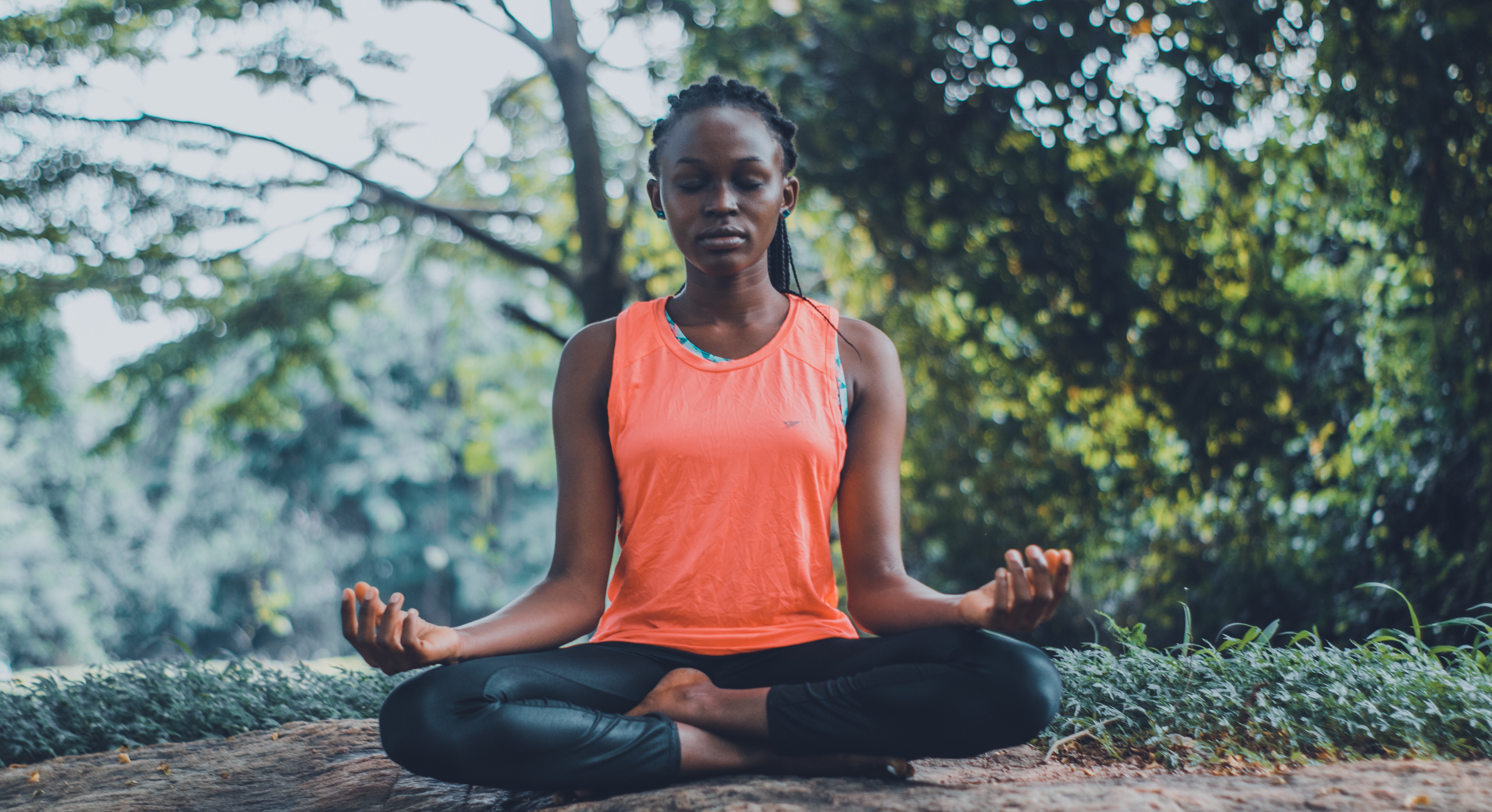 woman meditating amongst nature