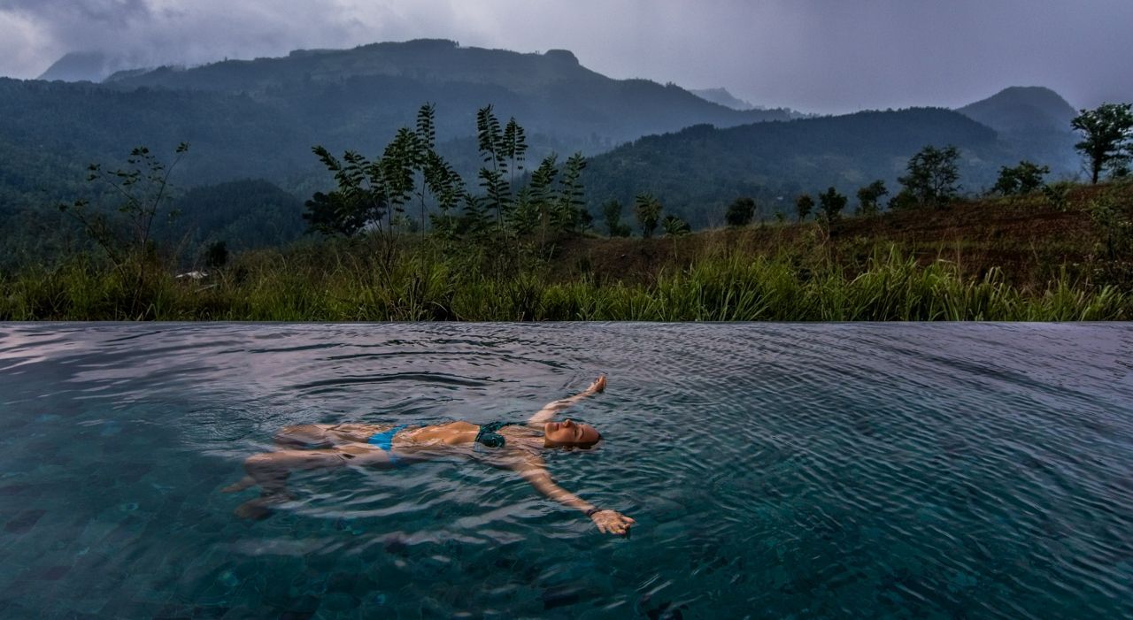 Woman floating in the pool at Santani Wellness Resort and Spa