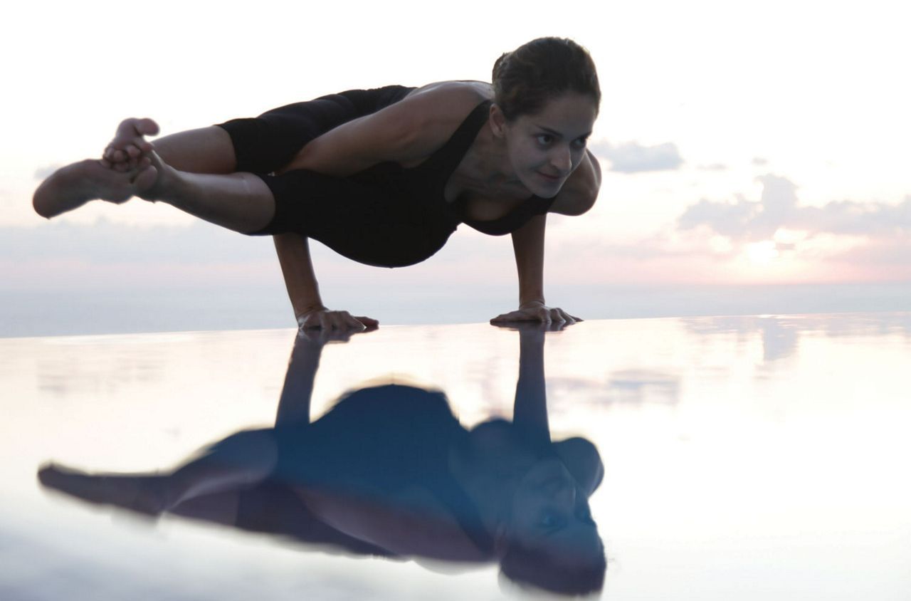 Woman doing a pose by the pool