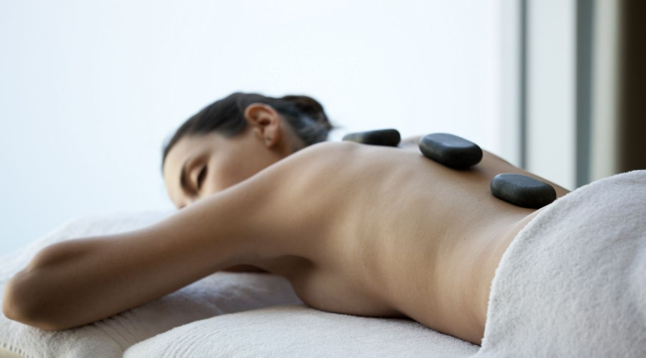 Woman having a stone massage on a wellness retreat