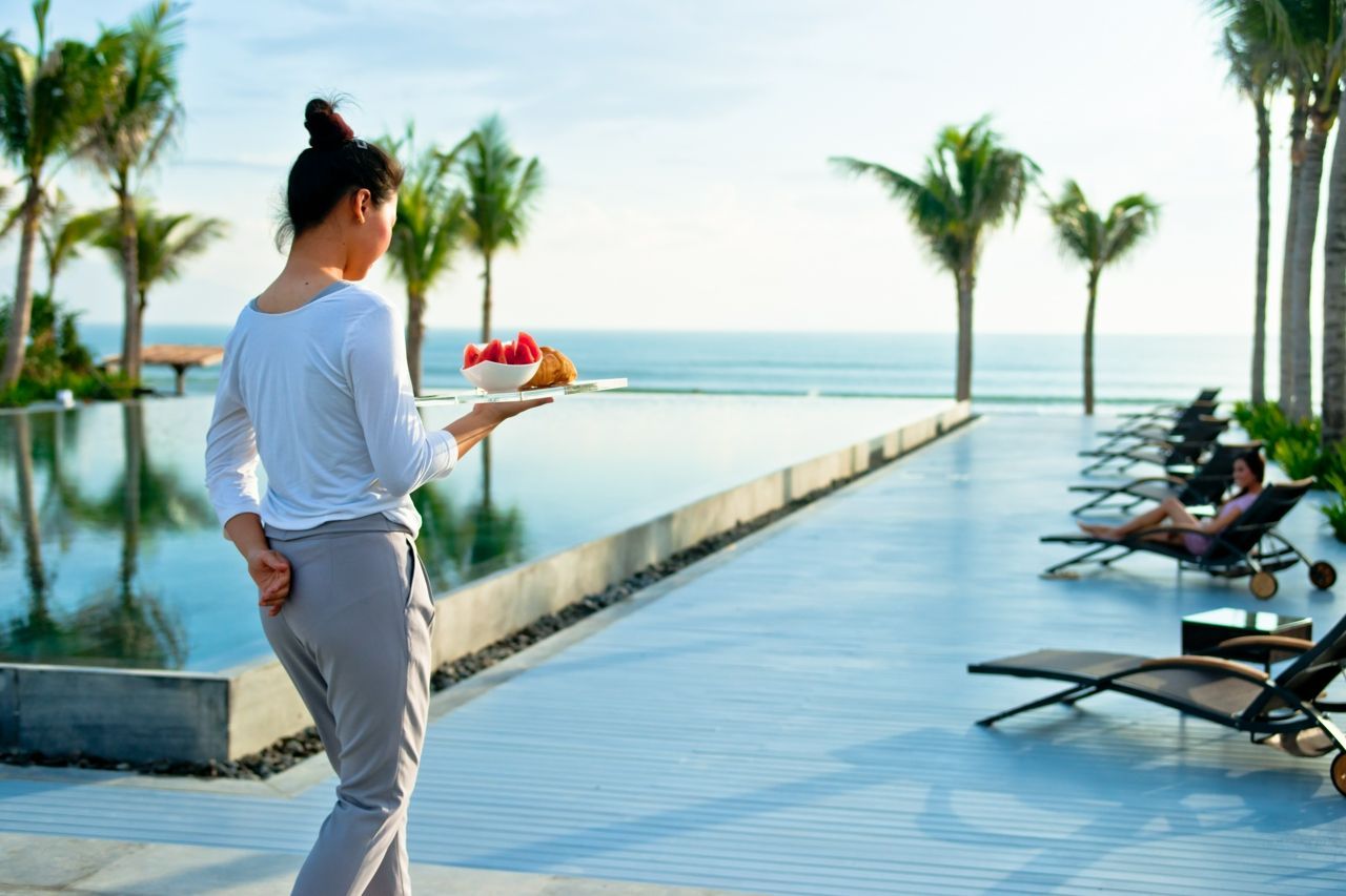A women holding bowl of fruits walking