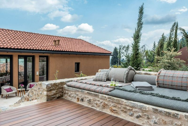 Patio with a bench with blankets and cushions at Euphoria Retreat
