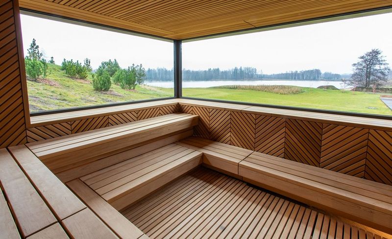 Vilnius Grand Resort's Sauna with views outside of the lake and hills