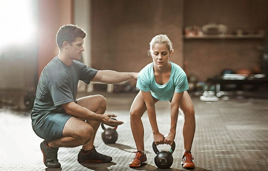 Women interval training with a kettlebell