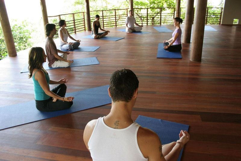 Group of people practicing yoga on a retreat
