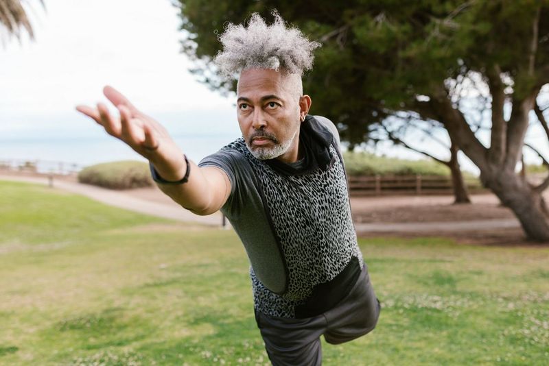 Man doing a yoga pose outdoors