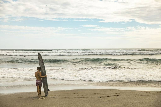 man with surfboard in Bali 