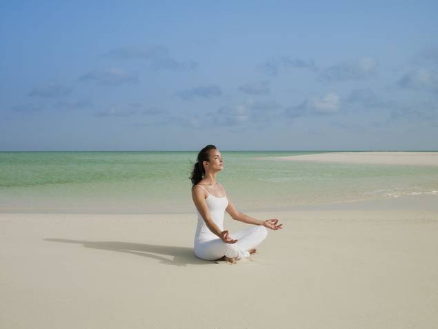 Woman doing yoga at COMO Parrot Cay.
