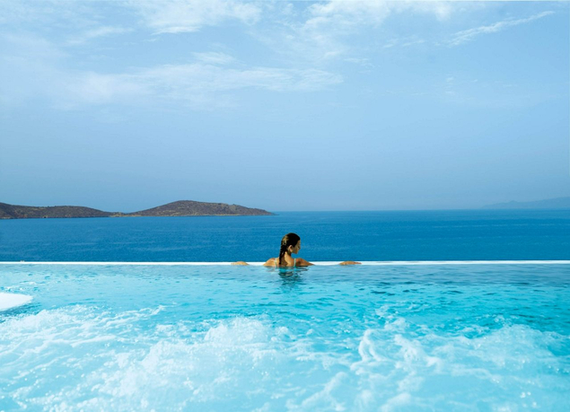 woman in infinity pool by the sea