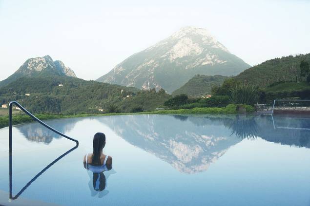 Woman looking at Italian mountain range at Lefay Resort