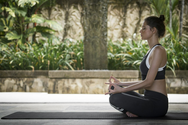 Woman meditating on outside deck