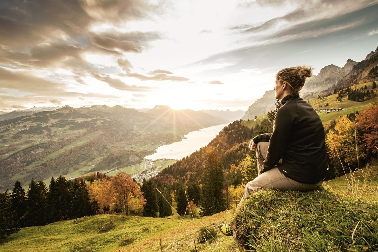 Woman sitting admiring the Swiss countryside whilst at Grand Resort Bad Ragaz
