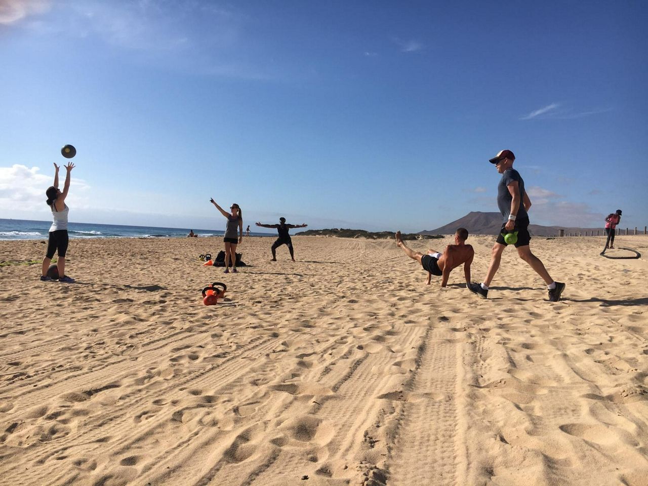 A group doing a workout together on the beach