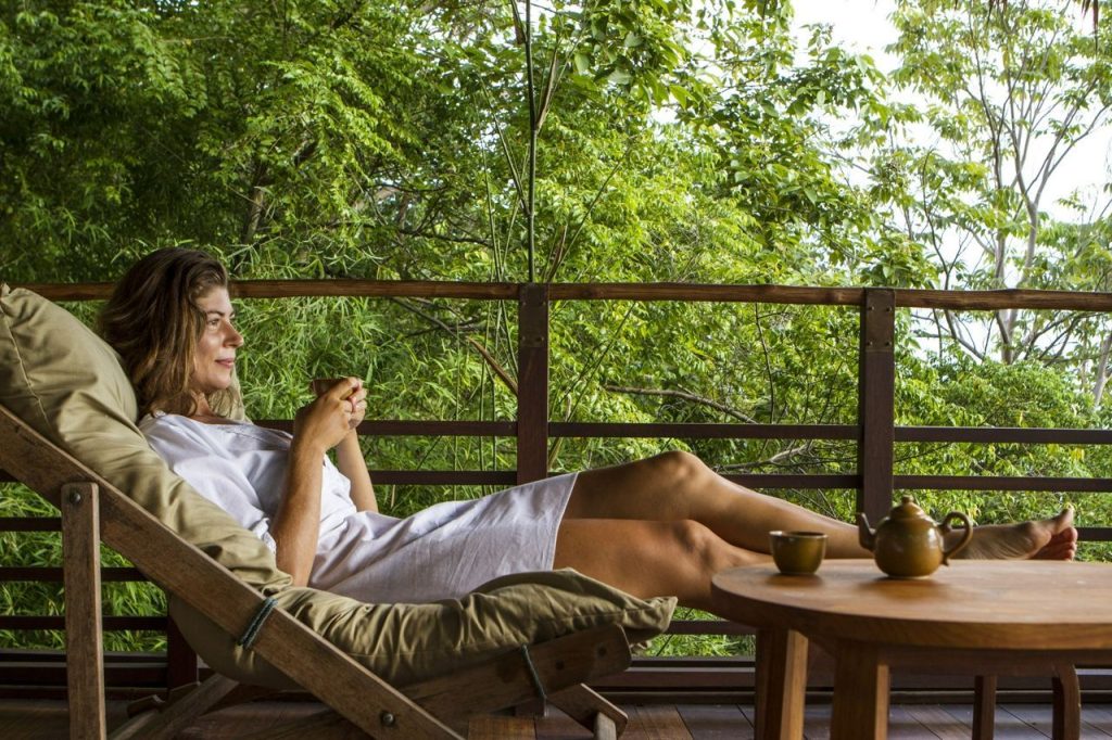 Woman sitting down and relaxing, looking at views on a Winter Wellness retreat