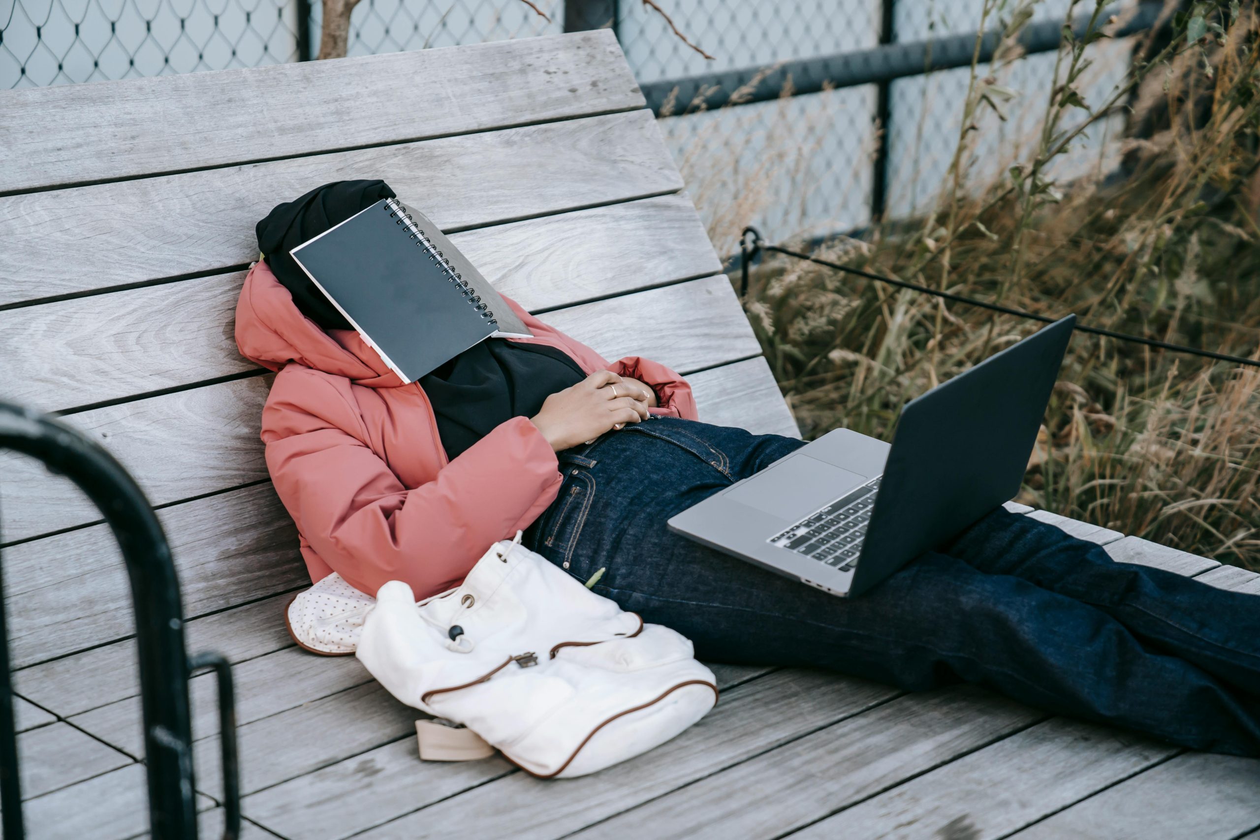 Person at work relaxing by tree 