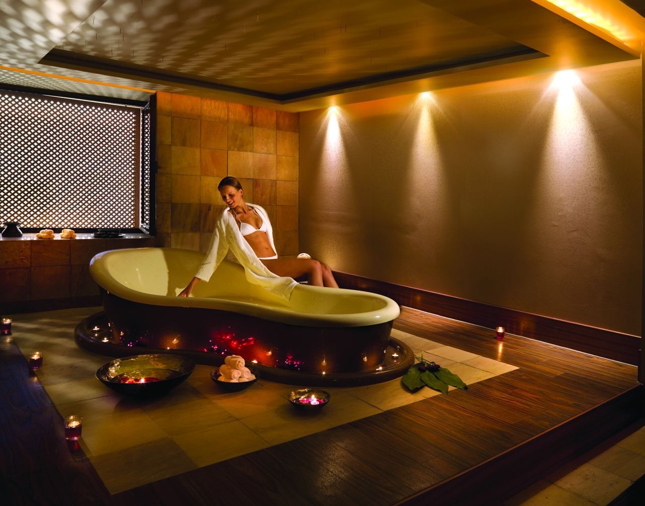 Woman getting into a relaxing and therapeutic bath at Porto Elounda in Greece