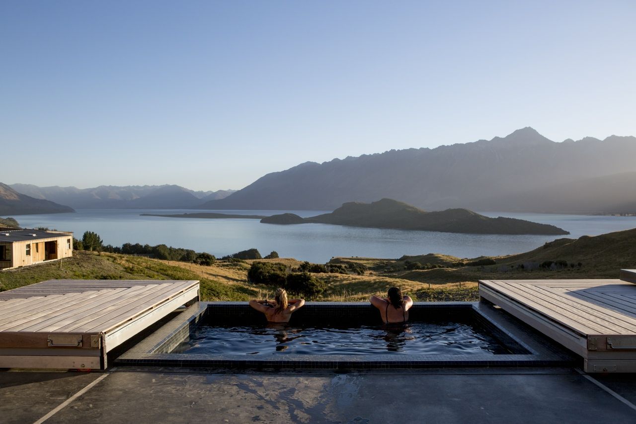 Couple looking out at the mountains from the swimming pool at Aro Ha in New Zealand