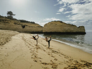 Guests practicing yoga on the beach at Vilalara Grand Hotel Algarve